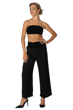 Load image into Gallery viewer, Woman wearing a black strapless top and wide-leg pants on a white background