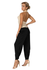 Load image into Gallery viewer, Woman wearing a beige top and black high-waisted pants on a white background
