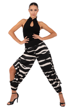 Load image into Gallery viewer, Woman wearing a black sleeveless top and zebra-striped pants on a white background