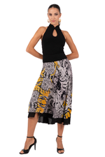 Load image into Gallery viewer, Woman wearing a black top and patterned skirt on a white background