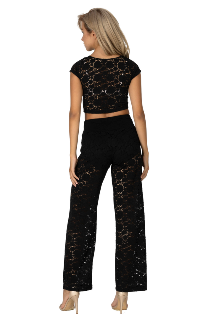 Woman wearing a black lace outfit on a white background