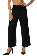 Load image into Gallery viewer, Black wide-leg pants worn by a person on a white background

