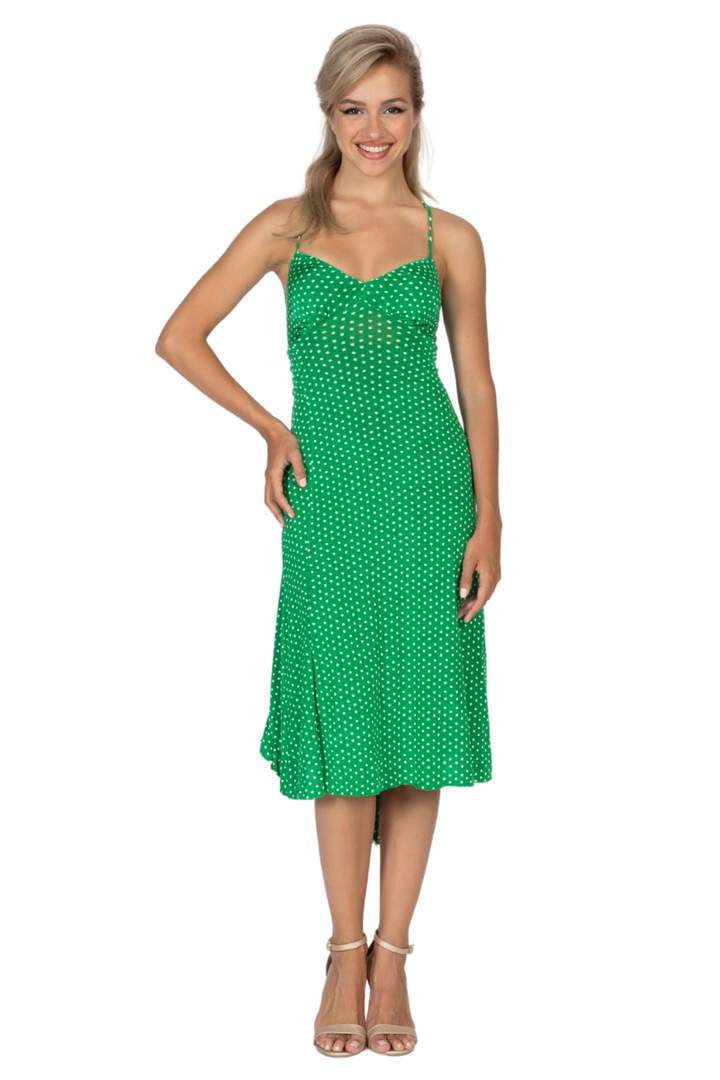 Woman wearing a green polka dot dress on a white background
