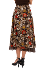 Load image into Gallery viewer, Floral patterned skirt worn by a person on a white background
