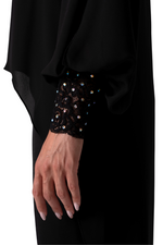 Load image into Gallery viewer, Black garment with beaded cuffs on a white background
