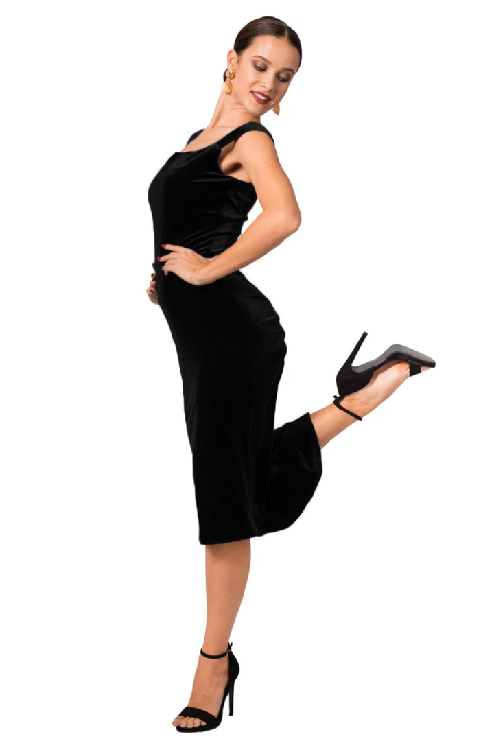 Woman wearing a black dress posing on a white background