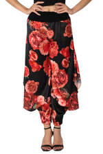 Load image into Gallery viewer, Black pants with red floral pattern worn by a person on a white background
