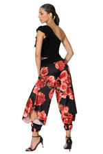 Load image into Gallery viewer, Woman wearing a black top and floral harem pants on a white background
